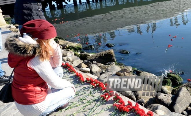 Baku residents bringing flowers to Seaside Boulevard to honor missing oil workers.  Azerbaijan, Dec.07, 2015